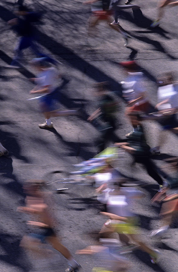 Spring Photograph - Runners along street in a marathon blurred and abstract by Jim Corwin