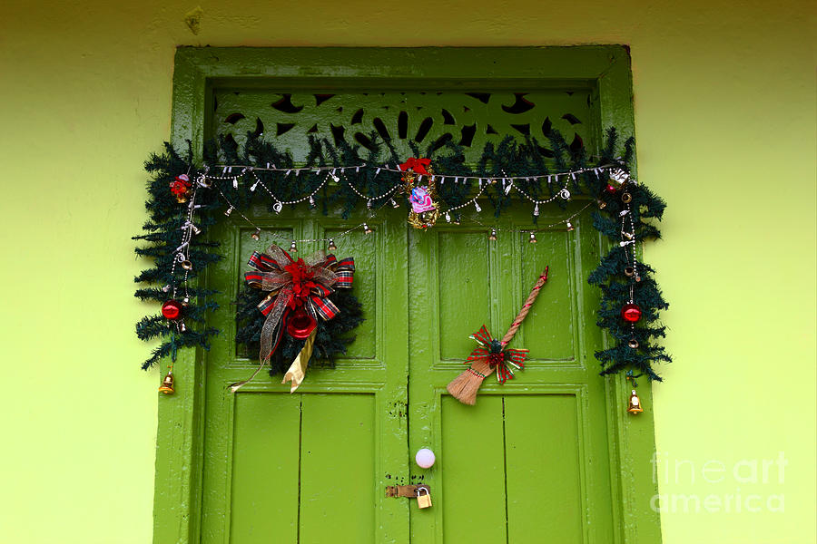 Christmas decorations on green door Panama Photograph by James Brunker