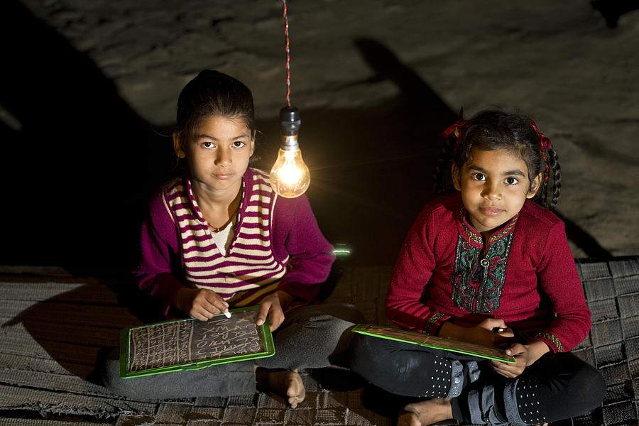 Rural girls studying in light bulb Photograph by Triloks