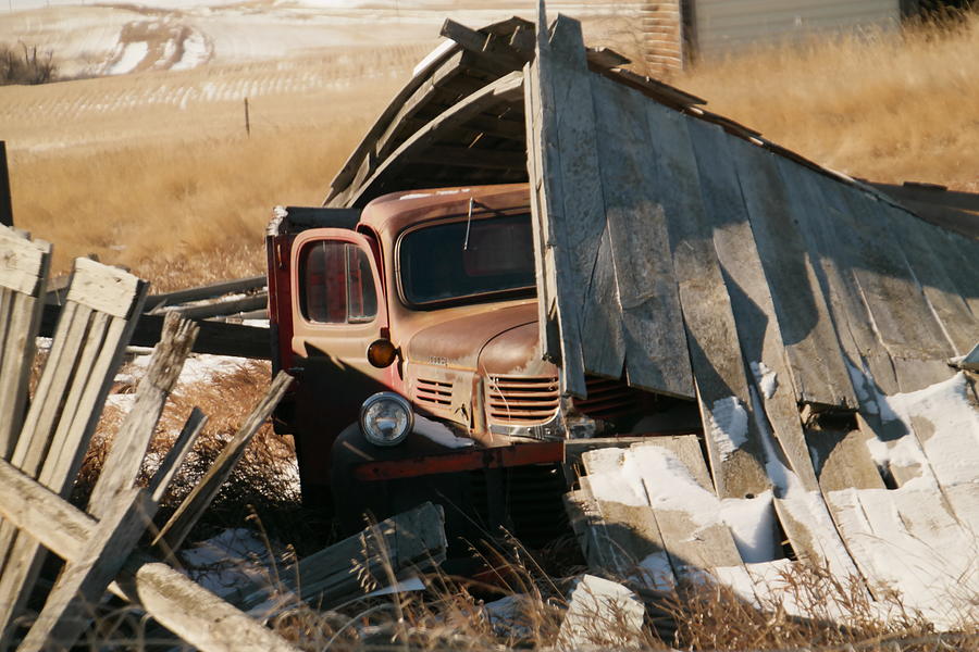 Rust under the fallen barn in Navaho Montana Photograph by Jeff Swan