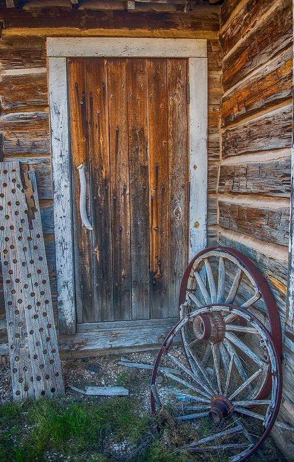 Rustic door and wagon wheels Photograph by Paul Freidlund