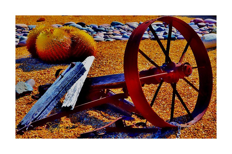 Landscape Photograph - Rusty Wheel by Sharon  Lavoie