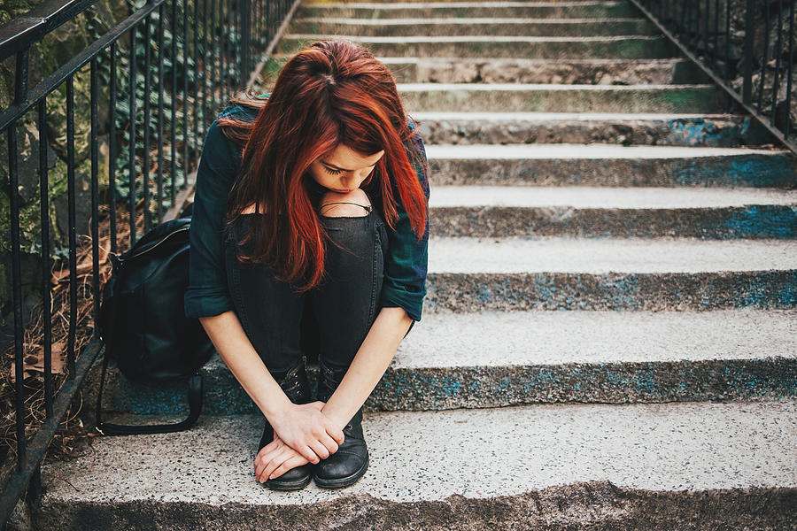 Sad lonely girl sitting on stairs Photograph by Pixelfit