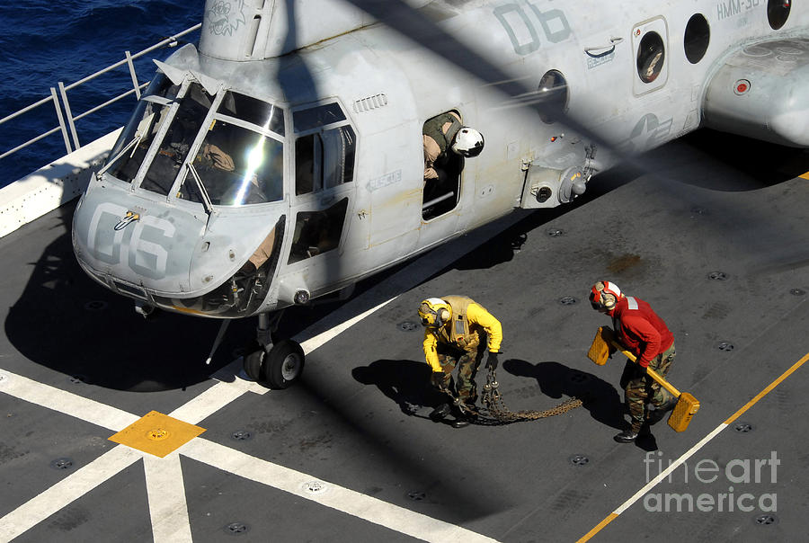 Transportation Photograph - Sailors Chock And Chain A Ch-46e Sea by Stocktrek Images