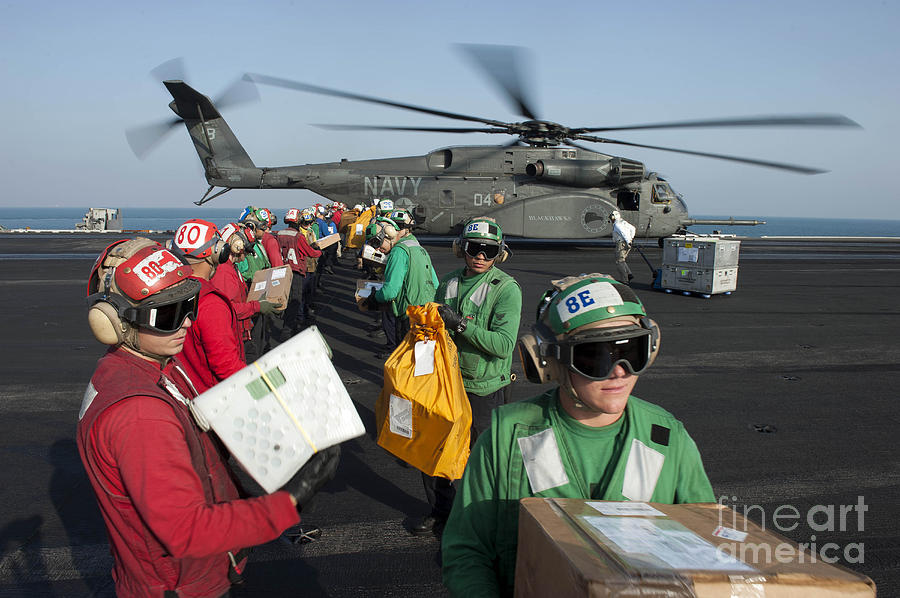 Sailors Unload Mail From An Mh-53e Sea Photograph by Stocktrek Images