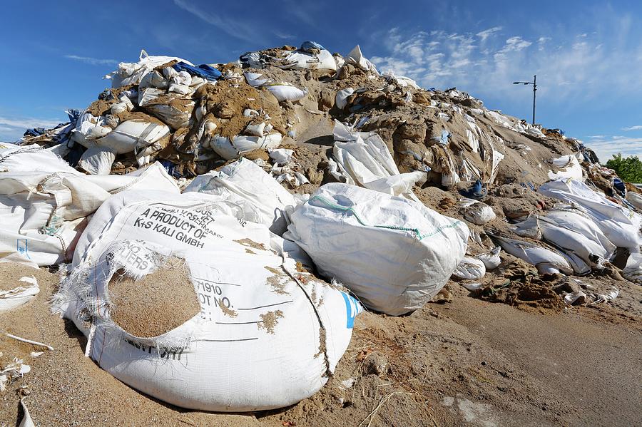 Summer Photograph - Sandbags In A Port After Flooding by Michael Szoenyi