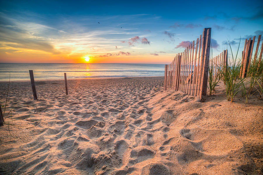 Sandy beach and Atlantic Ocean at sunrise, Outer Banks, North Carolina, USA Photograph by Rob Huber