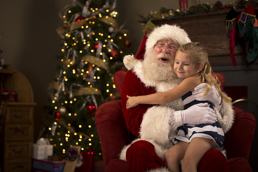 Santa Claus hugging a child Photograph by Inhauscreative
