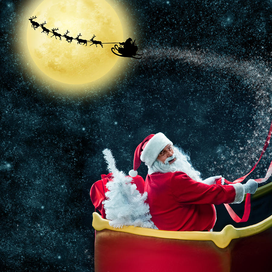 Santa Claus in his deer sled near the moon Photograph by VladGans