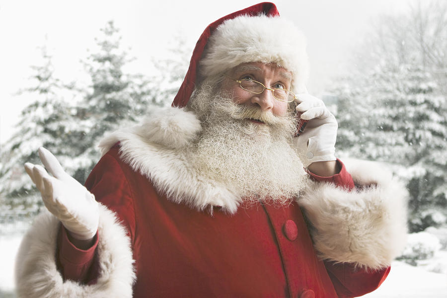 Santa Claus using mobile phone, close-up Photograph by Jose Luis Pelaez