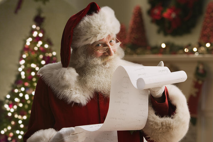Santa Claus with checklist, portrait, close-up Photograph by Jose Luis Pelaez