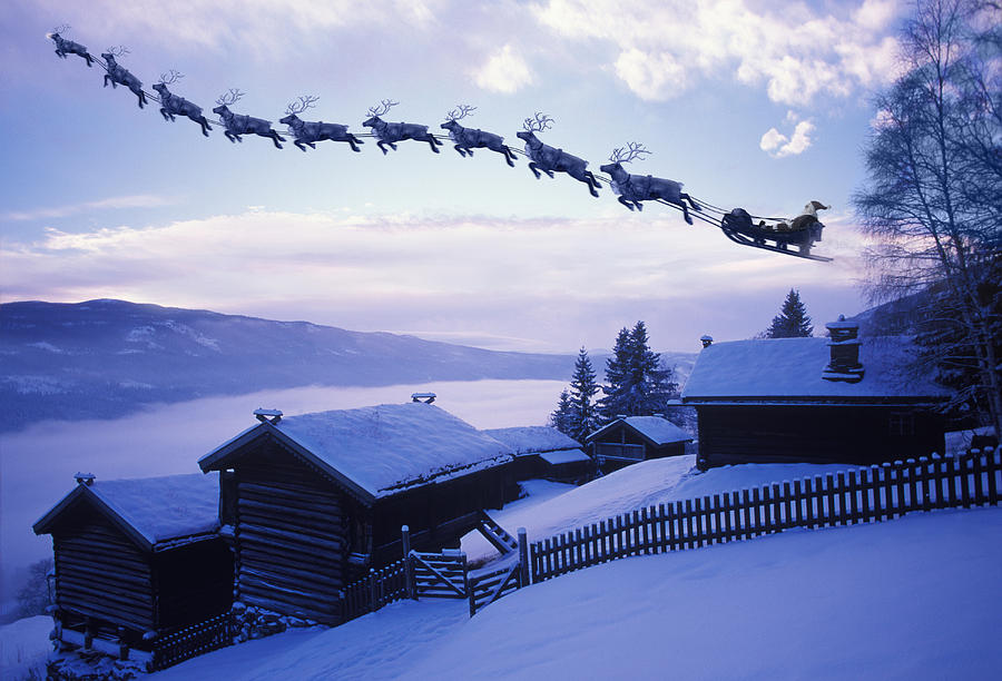 Santa Clause with reindeer flying above a farm Photograph by Per Breiehagen