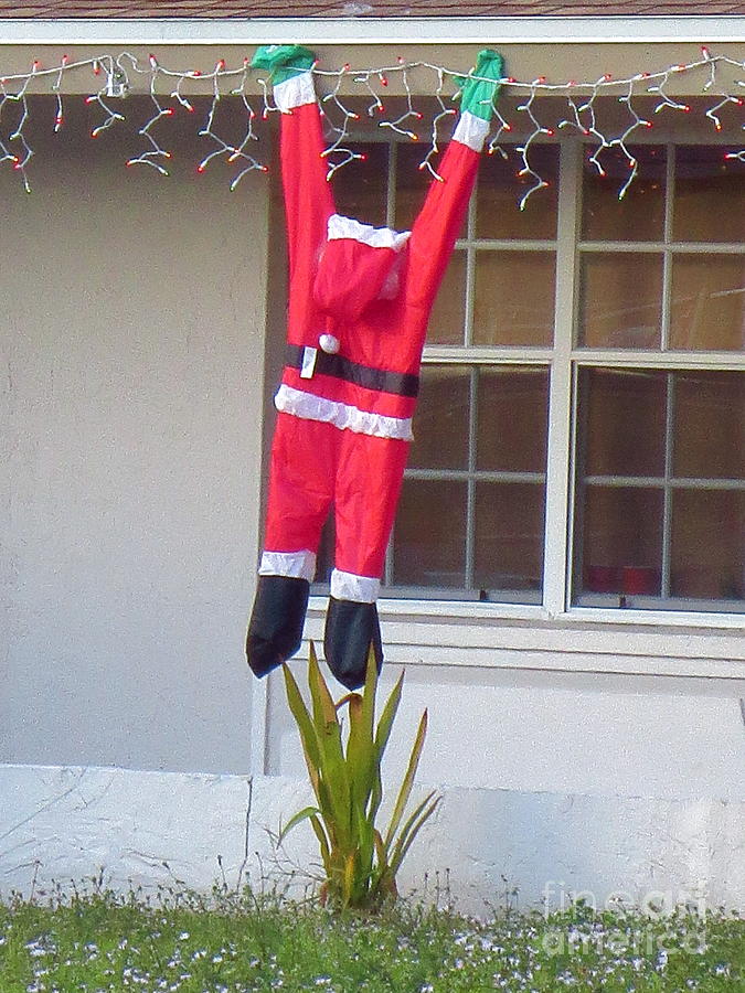Santa hanging from the roof in Ft. Myers Florida. Photograph by Robert Birkenes