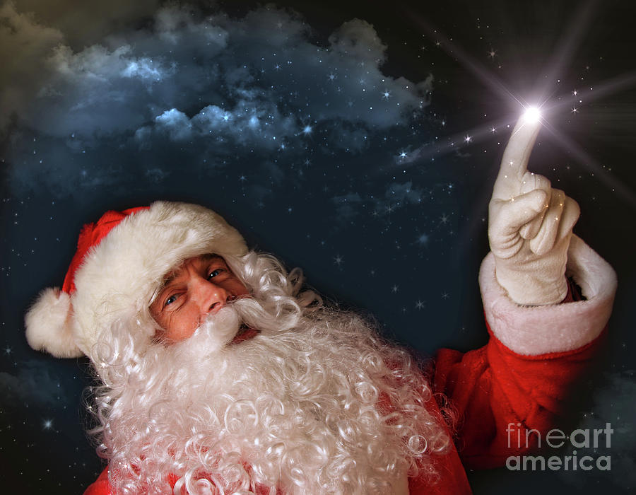 Christmas Photograph - Santa pointing with magical light to the sky by Sandra Cunningham