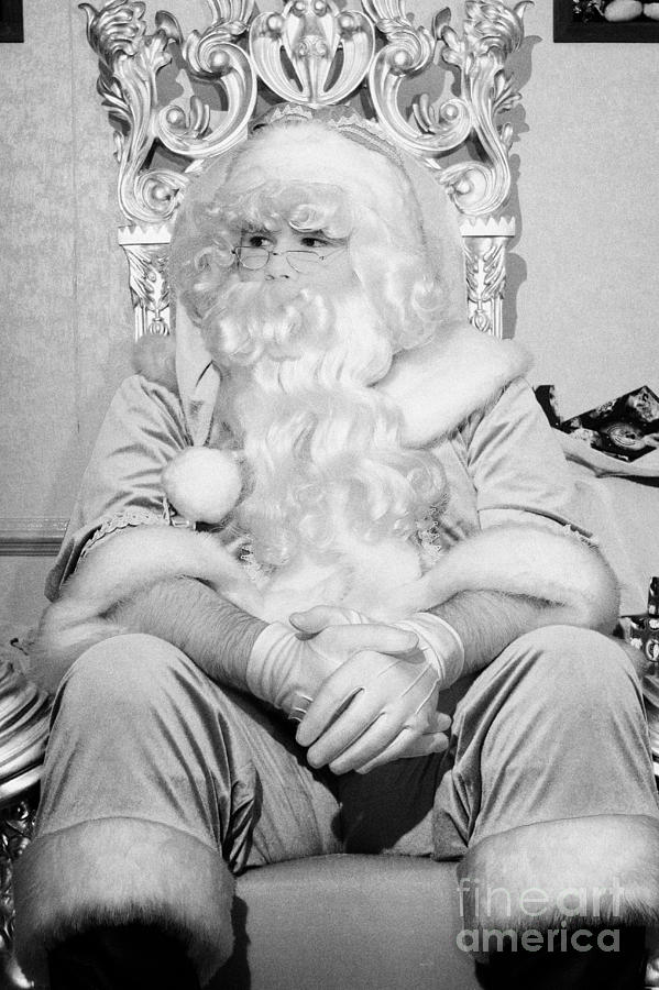 Christmas Photograph - Santa sitting on his throne looking away from camera in grotto set up  by Joe Fox