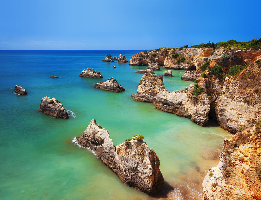 Saturated image of a colorful Algarve beach in Portugal Photograph by LucynaKoch