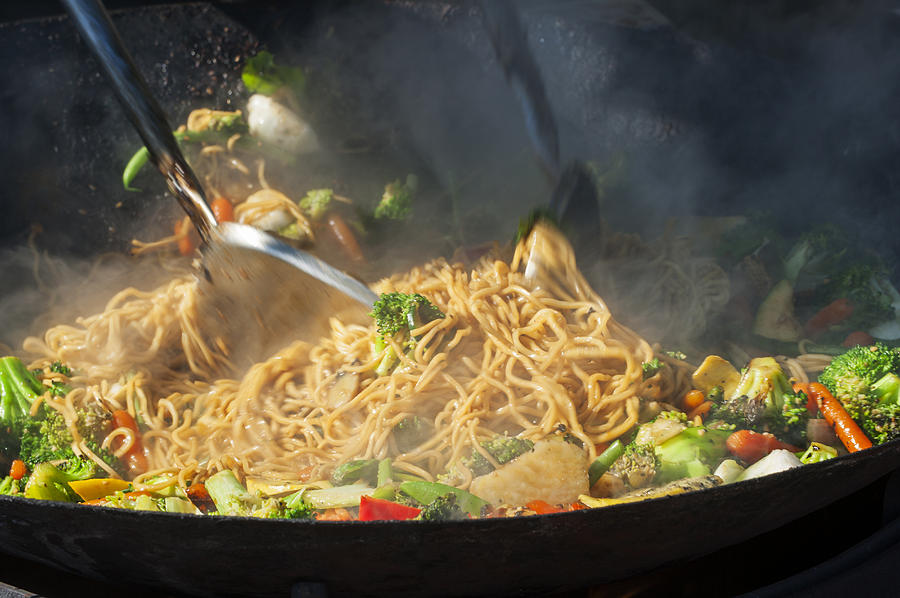 Sauteing chow mein in a wok Photograph by Brian Stablyk