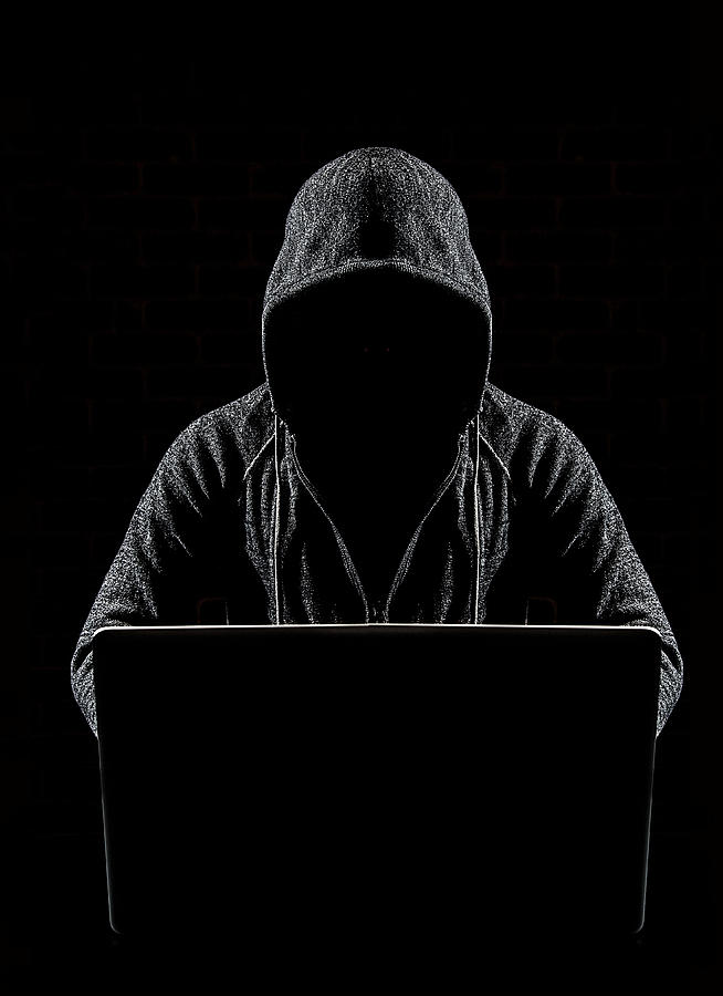Scary computer hacker Photograph by PM Images