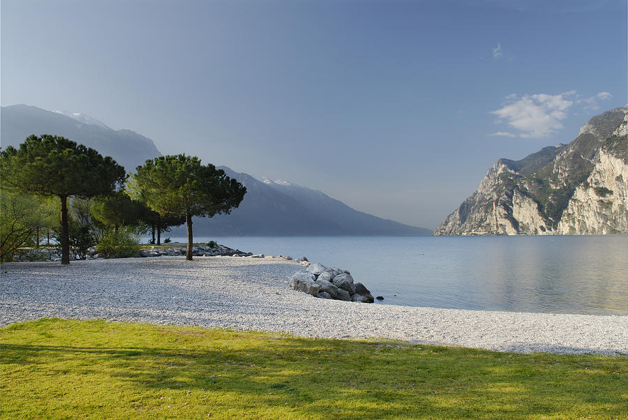 Scene of Riva Del Garda featuring water and mountains Photograph by AlbertoSimonetti