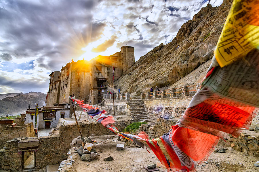 Scenic of leh palace with colorful omani prayer flag with dramatic sky in leh ladakh,india Photograph by Photo by Supoj Buranaprapapong