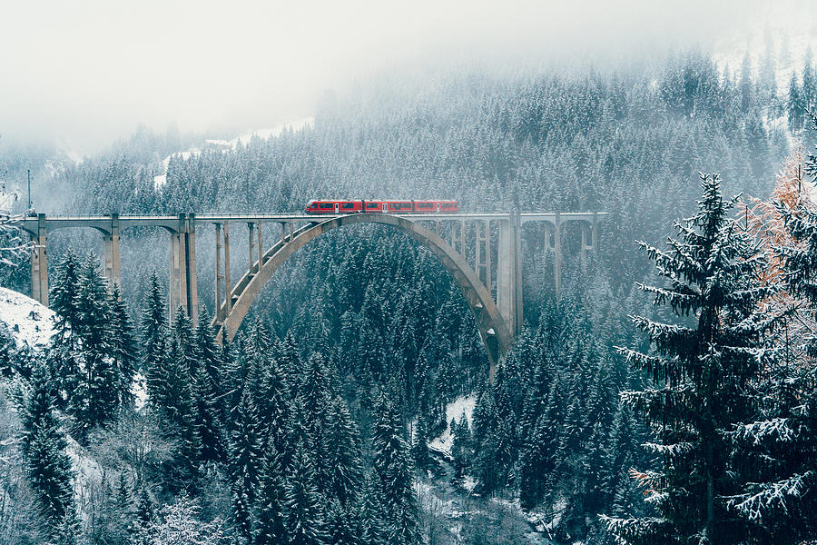 Scenic view of train on viaduct in Switzerland Photograph by Oleh_Slobodeniuk