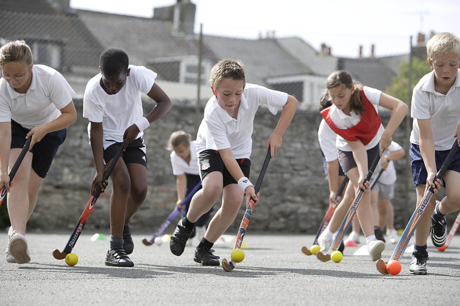 School Children Playing Hockey Photograph by Peter Cade