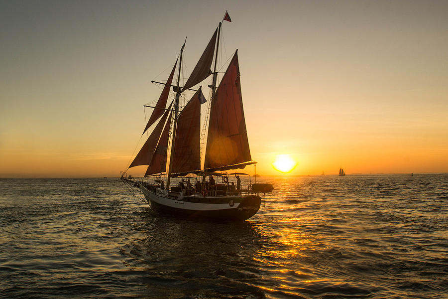 Schooner Setting Sail at Sunset Photograph by Danny Mongosa