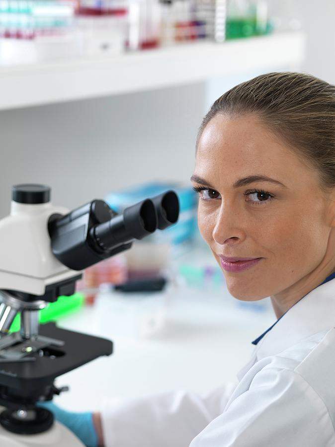 Scientist With Microscope by Tek Image