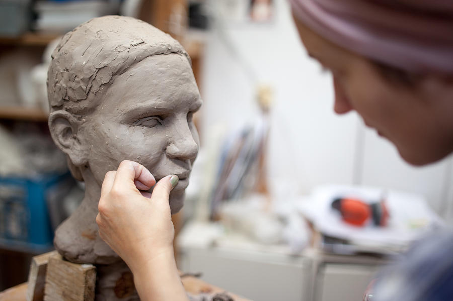 Sculptor working on head sculpture Photograph by Guido Mieth