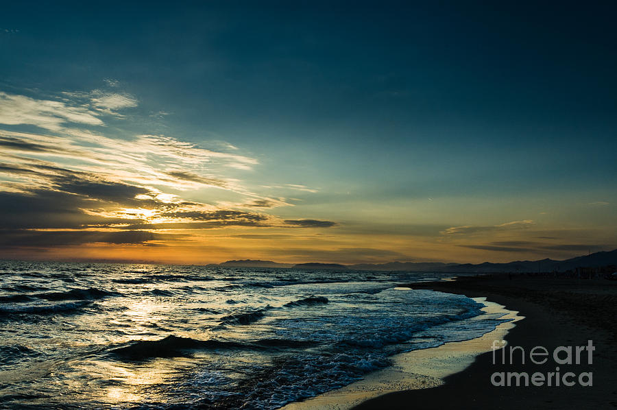 Sea shore setting sun on the Mediterranean coast Photograph by Peter Noyce
