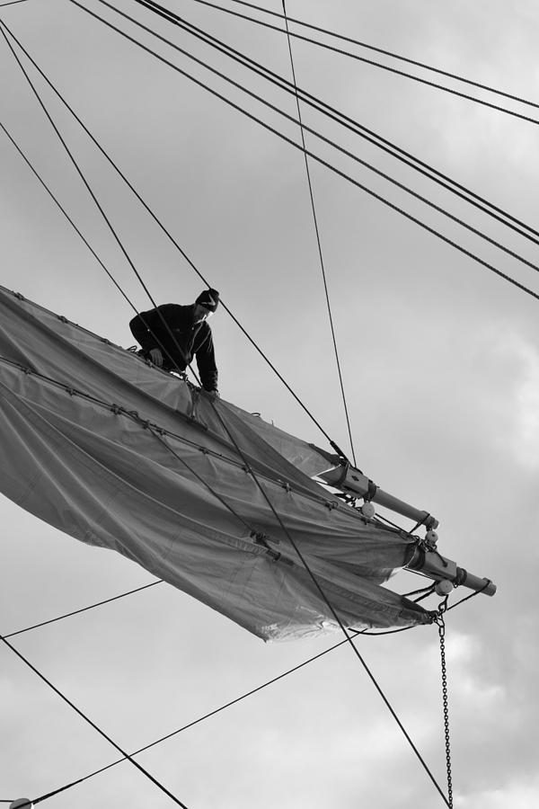 Seaman loosening a sail - monochrome Photograph by Ulrich Kunst And Bettina Scheidulin