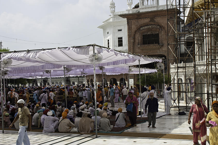 Seated devotees inside the Golden Temple Photograph by Ashish Agarwal