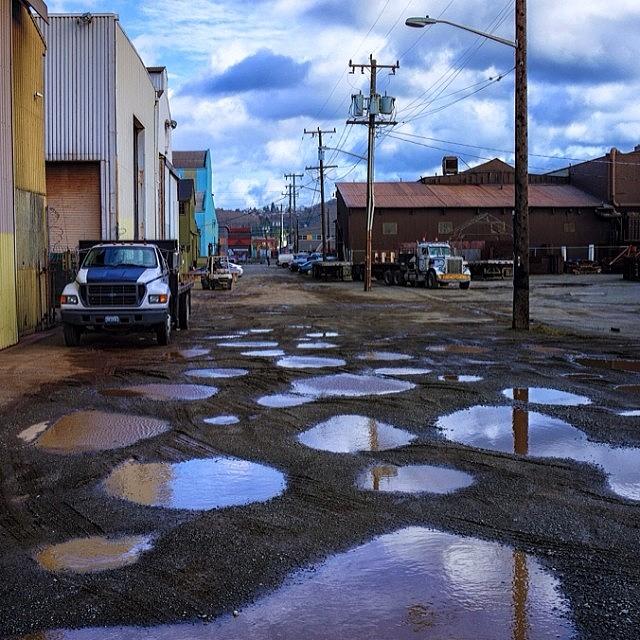 Seattle Photograph - #seattle #sodo #puddles by Ron Greer