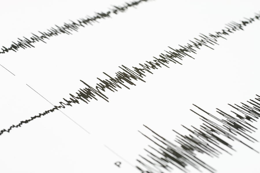 Seismic wave graph on a white paper Photograph by Barisonal