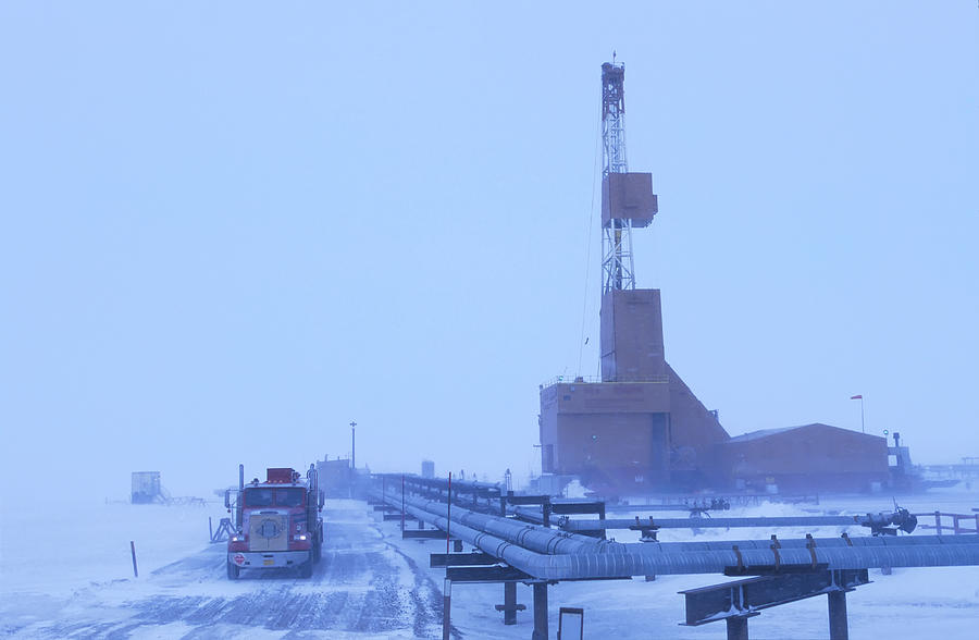 Semi passes drill rig in winter at Prudhoe Bay Photograph by Chris Arend