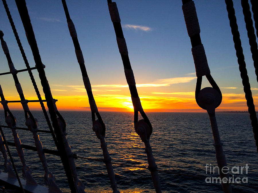 Sun set on sailing ship 2 Photograph by Jan Daniels