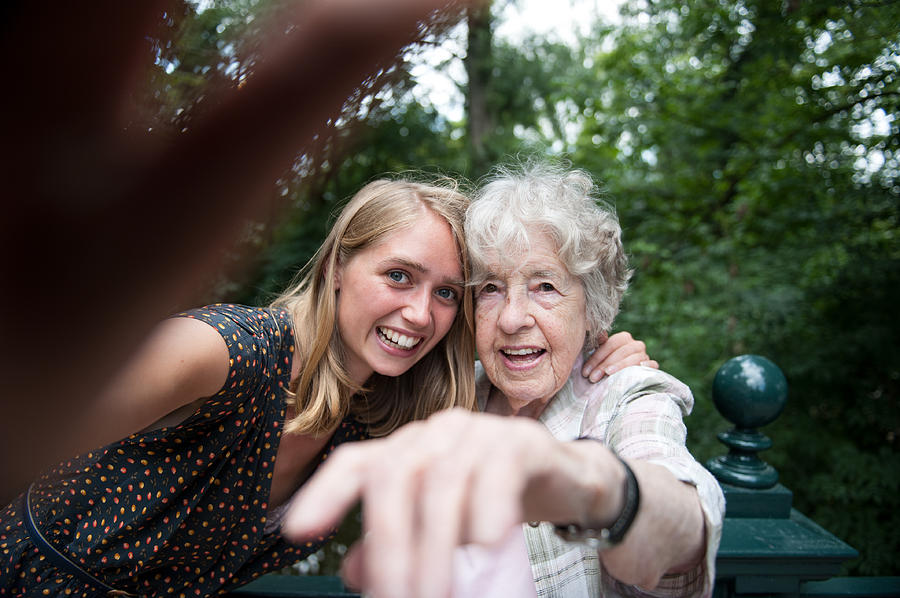Senior (98) lady and young woman making a selfie Photograph by Lucy Lambriex