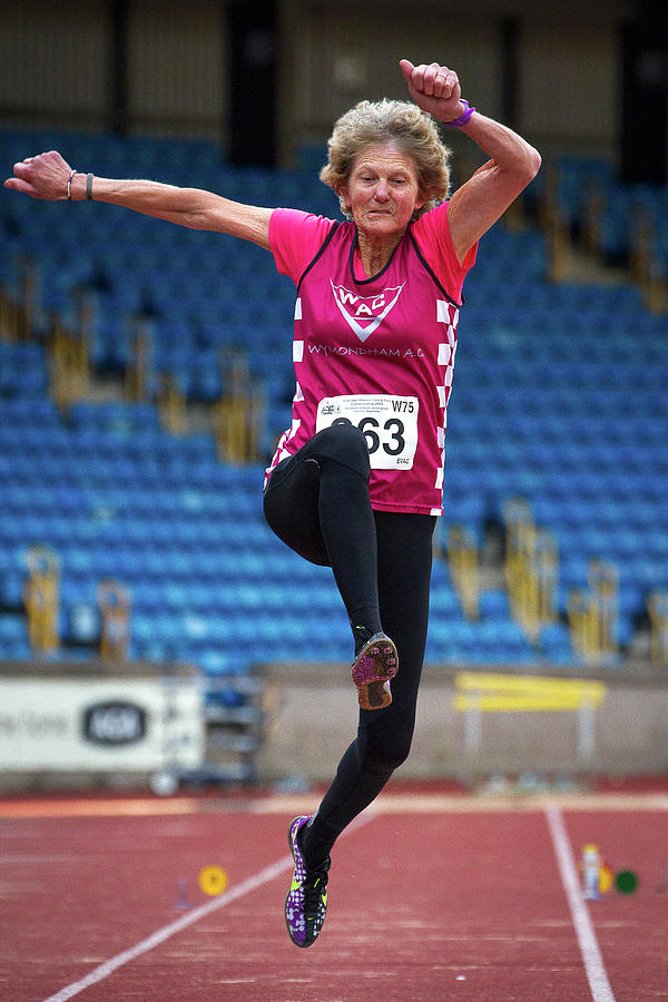 Senior British Female Athlete Mid-air Photograph by Alex Rotas