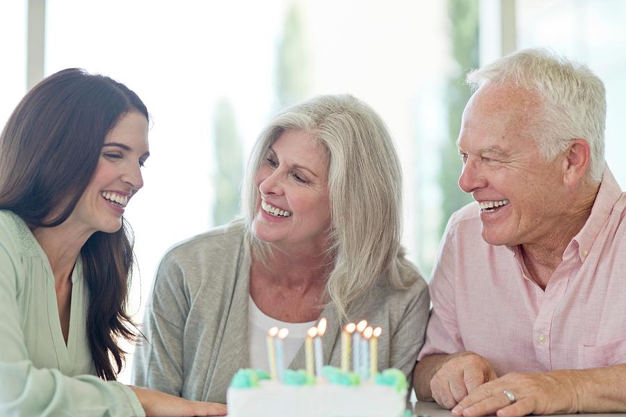 Senior Couple And Adult Daughter With Birthday Cake Photograph by Science Photo Library
