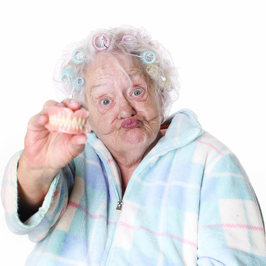 Senior Humor: woman holding false teeth Photograph by Bobbieo