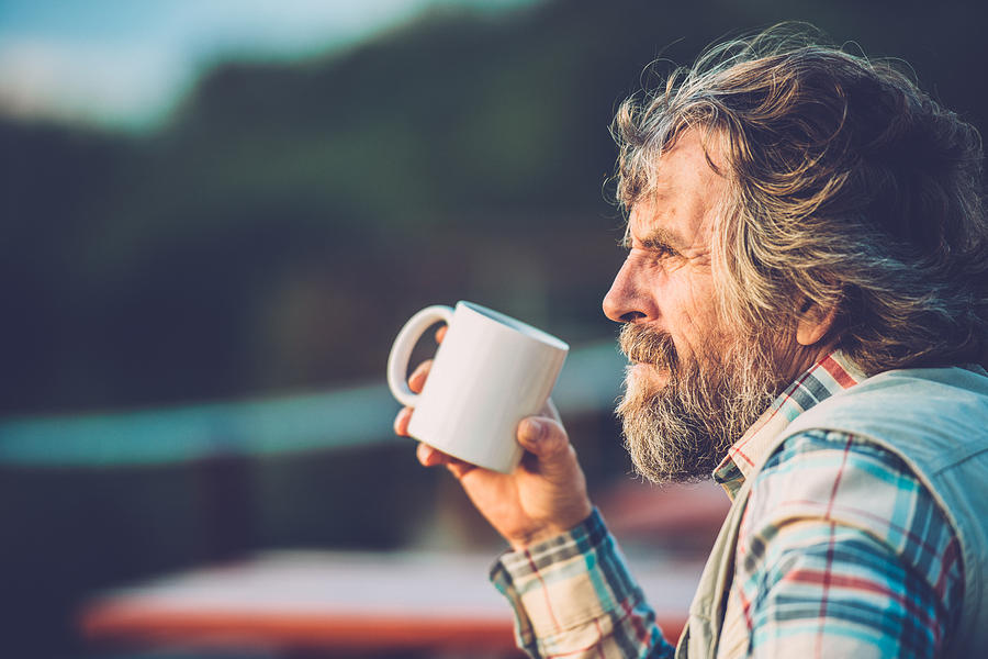 Senior Man Drinking a Coffee or a Tea Outdoors, Close-up Photograph by CasarsaGuru