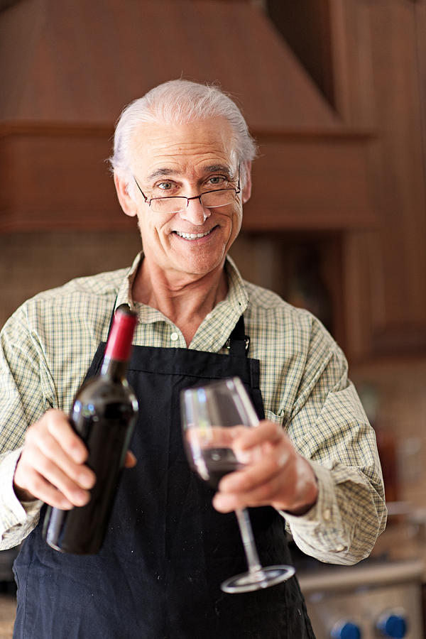 Senior man having a glass of wine Photograph by Lise Gagne