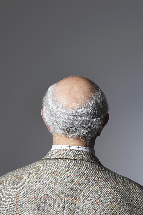 Senior Man in studio, head and shoulders, back view Photograph by Moodboard