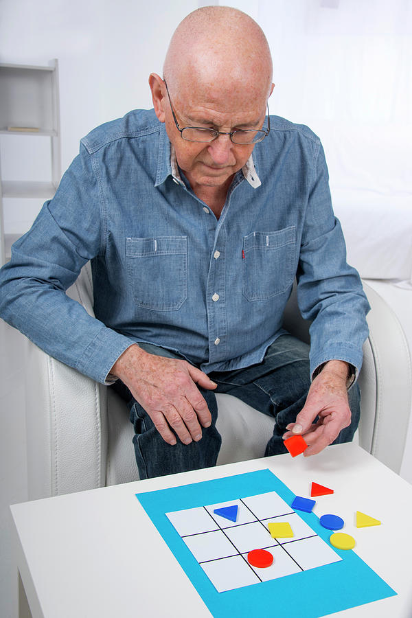Senior Man Playing Game Photograph by Lea Paterson/science Photo Library