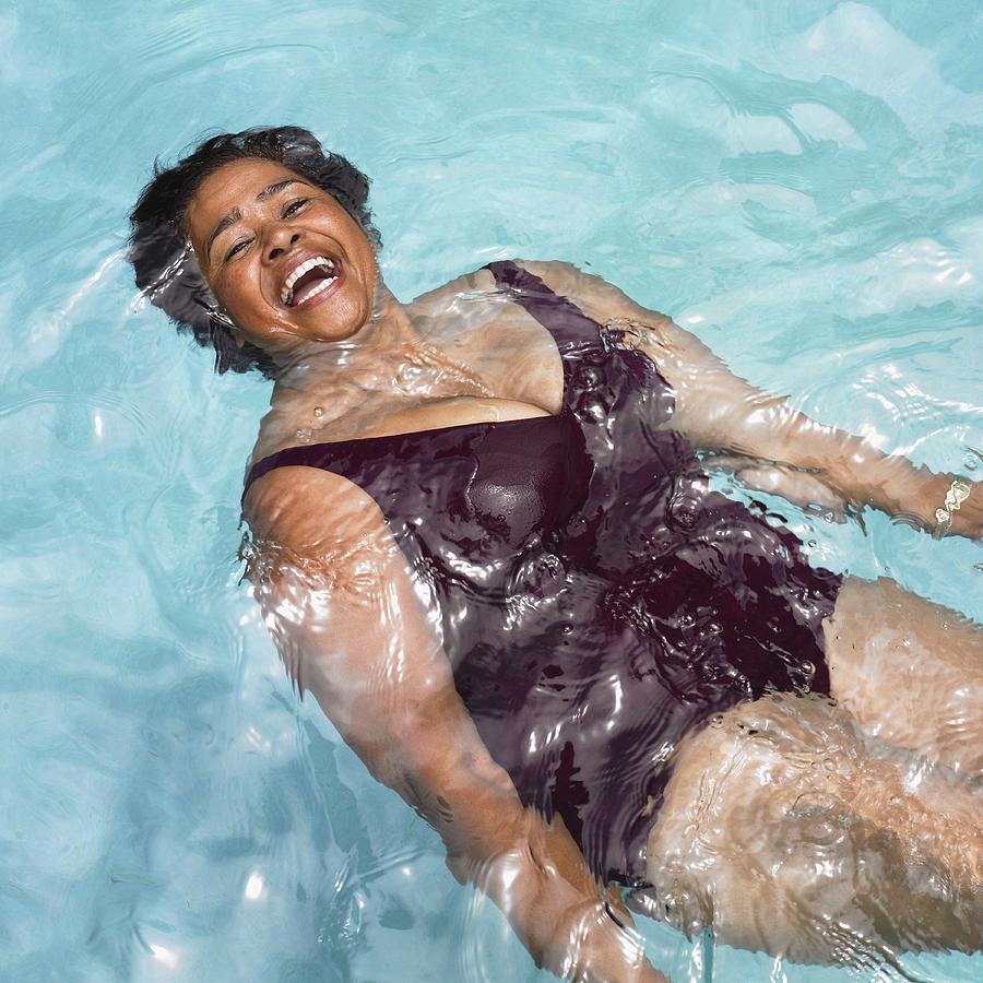 Senior Mixed Race woman in swimming pool Photograph by Blend Images - Dave & Les Jacobs