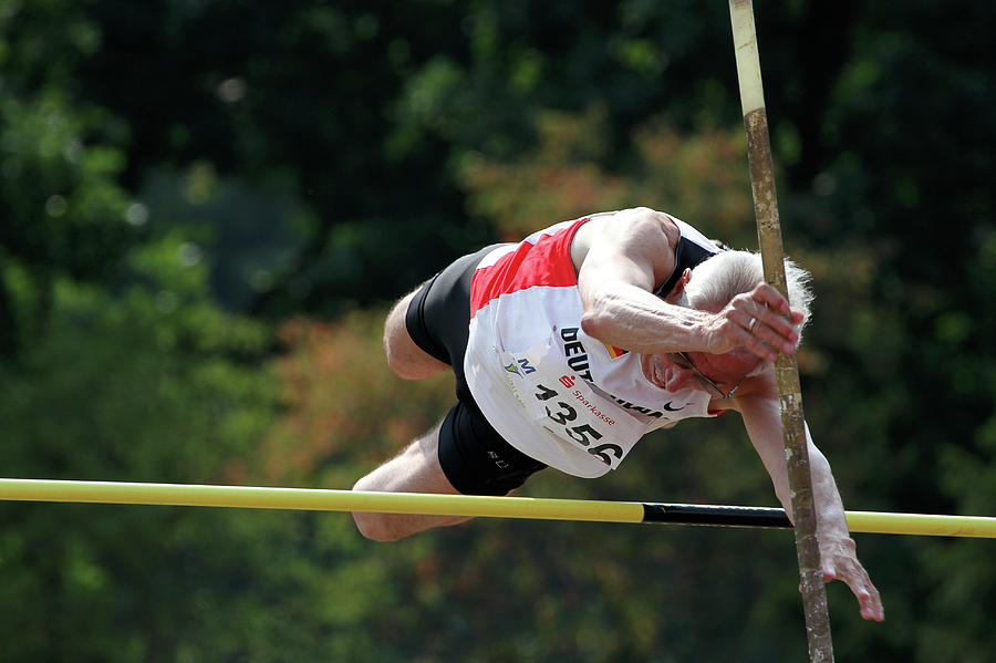 Senior Pole Vaulter Clearing The Bar Photograph by Alex Rotas