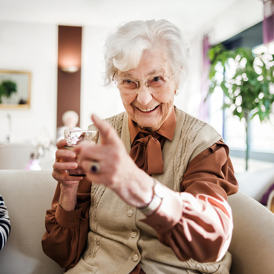Senior Woman At Sofa Having Fun Photograph by Hinterhaus Productions