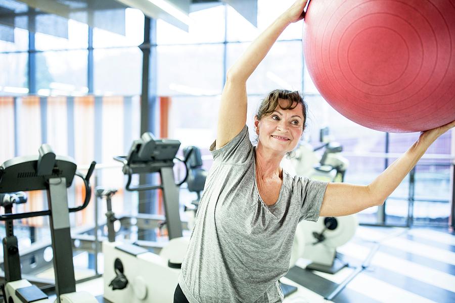 Senior Woman Exercising With Fitness Ball Photograph by Science Photo Library