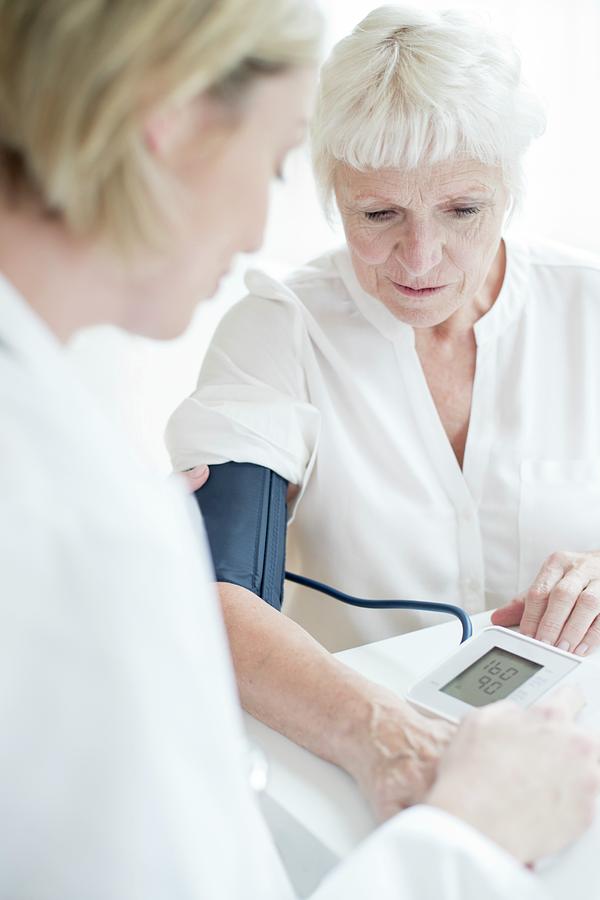 Senior Woman Having Blood Pressure Taken Photograph by Science Photo Library