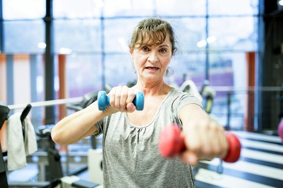 Senior Woman Holding Dumbbells Photograph by Science Photo Library
